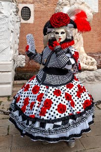 People in costume at the Venice Carnival in front of the Venetian Arsenal.