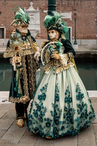 People in costume at the Venice Carnival in front of the Venetian Arsenal.