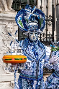 People in costume at the Venice Carnival in front of the Venetian Arsenal.