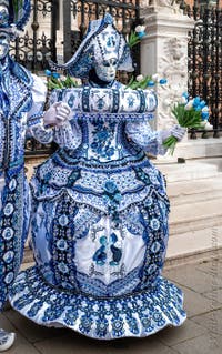 People in costume at the Venice Carnival in front of the Venetian Arsenal.