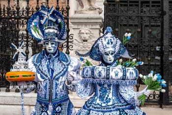 People in costume at the Venice Carnival in front of the Venetian Arsenal.