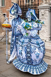 People in costume at the Venice Carnival in front of the Venetian Arsenal.