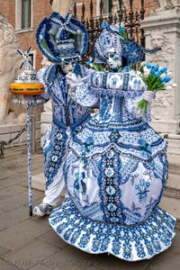 People in costume at the Venice Carnival in front of the Venetian Arsenal.