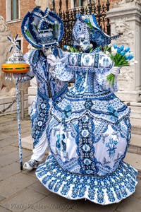 People in costume at the Venice Carnival in front of the Venetian Arsenal.