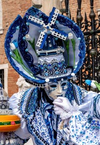 People in costume at the Venice Carnival in front of the Venetian Arsenal.