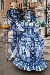 People in costume at the Venice Carnival in front of the Venetian Arsenal.