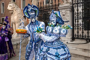 People in costume at the Venice Carnival in front of the Venetian Arsenal.