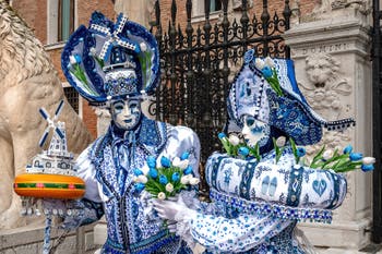 People in costume at the Venice Carnival in front of the Venetian Arsenal.