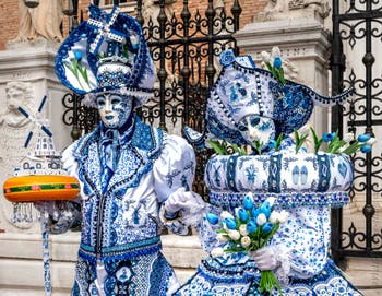 People in costume at the Venice Carnival in front of the Venetian Arsenal.