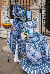 People in costume at the Venice Carnival in front of the Venetian Arsenal.