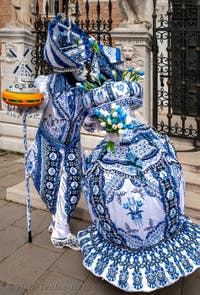 People in costume at the Venice Carnival in front of the Venetian Arsenal.