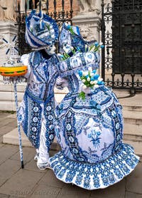 People in costume at the Venice Carnival in front of the Venetian Arsenal.