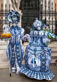 People in costume at the Venice Carnival in front of the Venetian Arsenal.