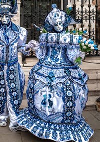 People in costume at the Venice Carnival in front of the Venetian Arsenal.