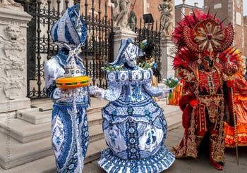 People in costume at the Venice Carnival in front of the Venetian Arsenal.