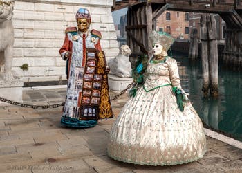 People in costume at the Venice Carnival in front of the Venetian Arsenal.