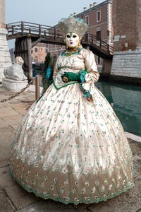 People in costume at the Venice Carnival in front of the Venetian Arsenal.