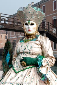 People in costume at the Venice Carnival in front of the Venetian Arsenal.