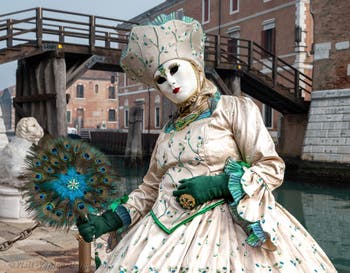 People in costume at the Venice Carnival in front of the Venetian Arsenal.