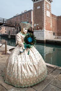 People in costume at the Venice Carnival in front of the Venetian Arsenal.