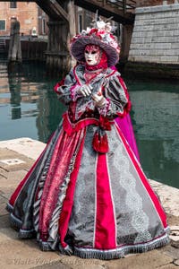 People in costume at the Venice Carnival in front of the Venetian Arsenal.