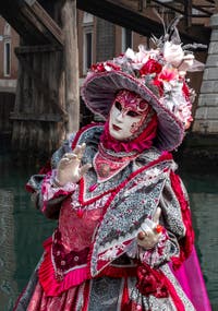 People in costume at the Venice Carnival in front of the Venetian Arsenal.