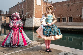 People in costume at the Venice Carnival in front of the Venetian Arsenal.