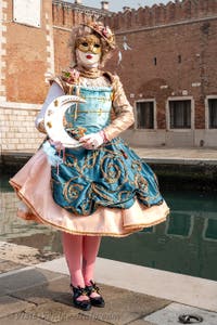 People in costume at the Venice Carnival in front of the Venetian Arsenal.