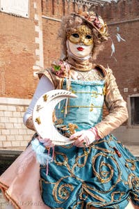 People in costume at the Venice Carnival in front of the Venetian Arsenal.