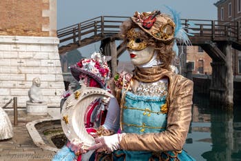 People in costume at the Venice Carnival in front of the Venetian Arsenal.