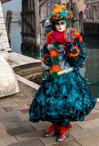 People in costume at the Venice Carnival in front of the Venetian Arsenal.