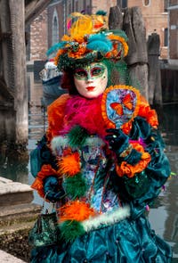 People in costume at the Venice Carnival in front of the Venetian Arsenal.