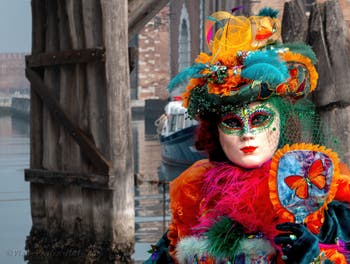 People in costume at the Venice Carnival in front of the Venetian Arsenal.