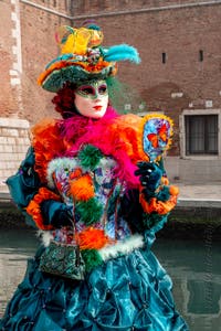 People in costume at the Venice Carnival in front of the Venetian Arsenal.