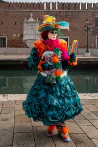 People in costume at the Venice Carnival in front of the Venetian Arsenal.