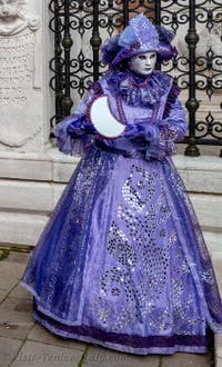 People in costume at the Venice Carnival in front of the Venetian Arsenal.