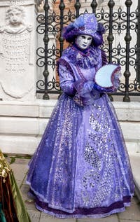 People in costume at the Venice Carnival in front of the Venetian Arsenal.