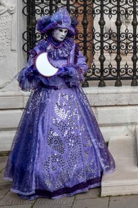 People in costume at the Venice Carnival in front of the Venetian Arsenal.