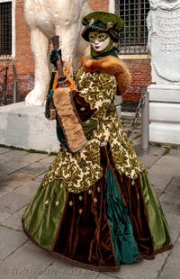 People in costume at the Venice Carnival in front of the Venetian Arsenal.