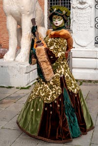 People in costume at the Venice Carnival in front of the Venetian Arsenal.