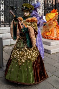 People in costume at the Venice Carnival in front of the Venetian Arsenal.