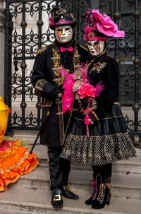 People in costume at the Venice Carnival in front of the Venetian Arsenal.