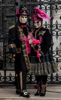 People in costume at the Venice Carnival in front of the Venetian Arsenal.