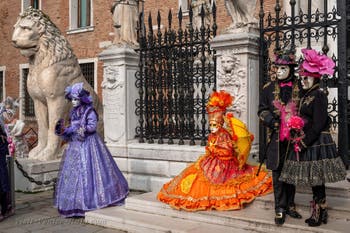 People in costume at the Venice Carnival in front of the Venetian Arsenal.