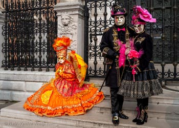 People in costume at the Venice Carnival in front of the Venetian Arsenal.