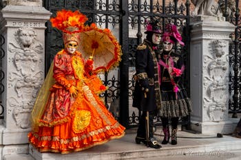 People in costume at the Venice Carnival in front of the Venetian Arsenal.