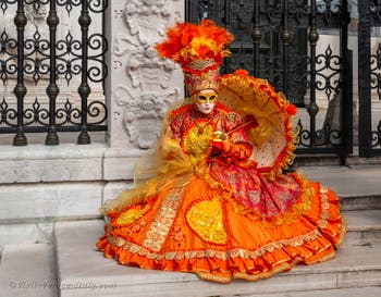 People in costume at the Venice Carnival in front of the Venetian Arsenal.