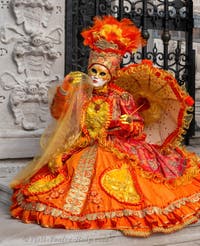 People in costume at the Venice Carnival in front of the Venetian Arsenal.