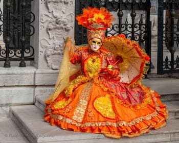 People in costume at the Venice Carnival in front of the Venetian Arsenal.