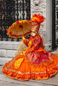 People in costume at the Venice Carnival in front of the Venetian Arsenal.